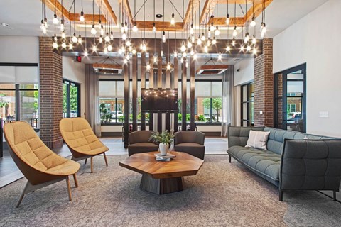 a living room with couches and chairs and a table